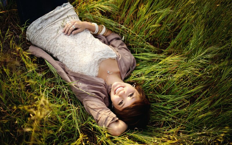 woman lying in grass smiling