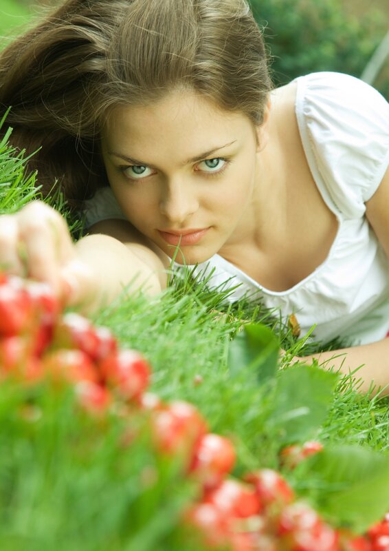 woman lying in grass with berries