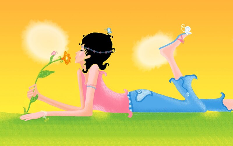 Woman lying in grass with flower
