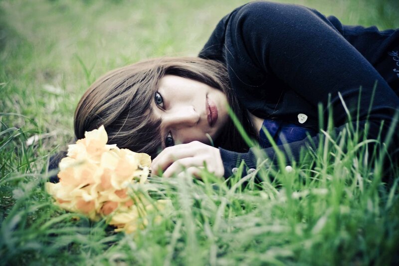 woman lying in grass with flowers