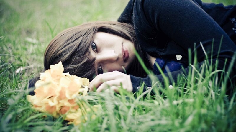 woman lying in grass with flowers
