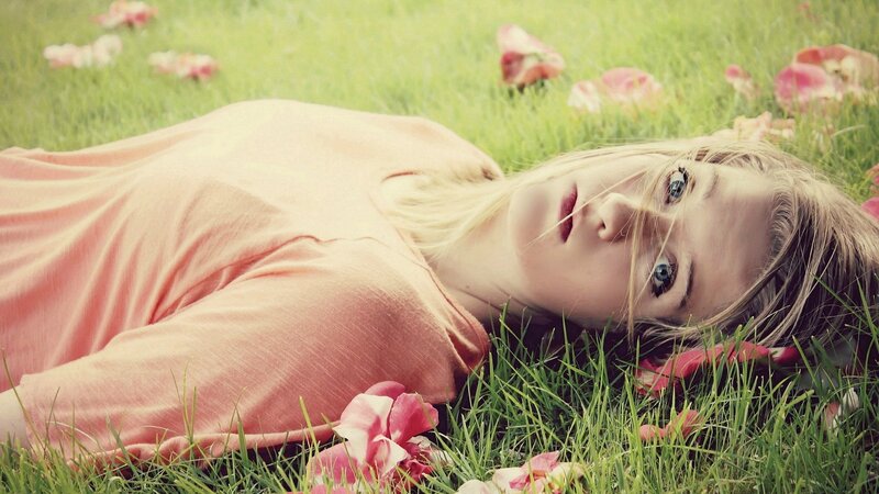 woman lying in grass with flowers