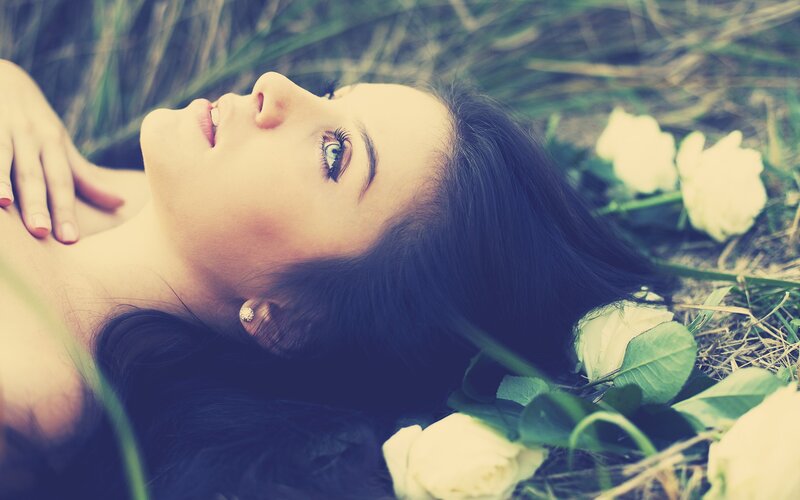 woman lying in grass with flowers
