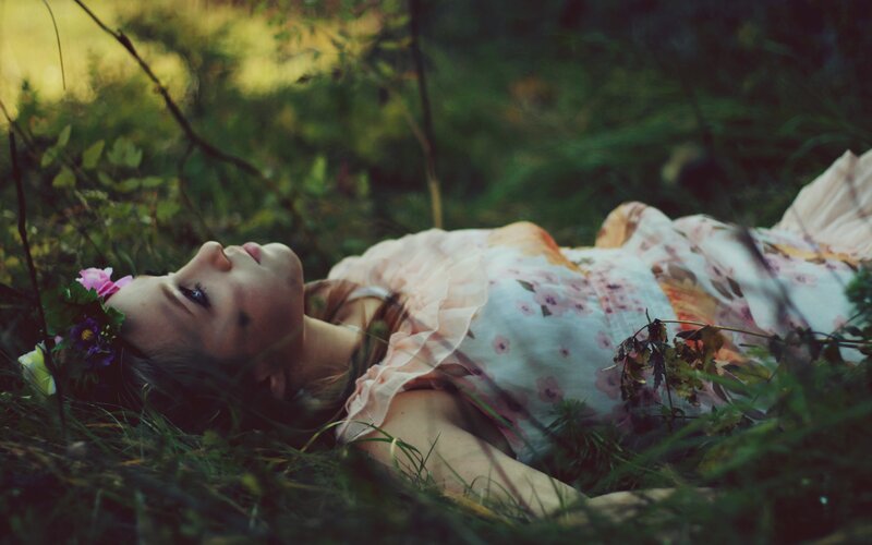 woman lying in grass with flowers