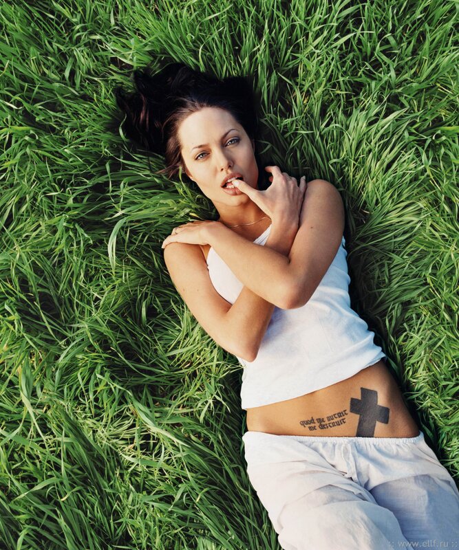 woman lying in grass with tattoo