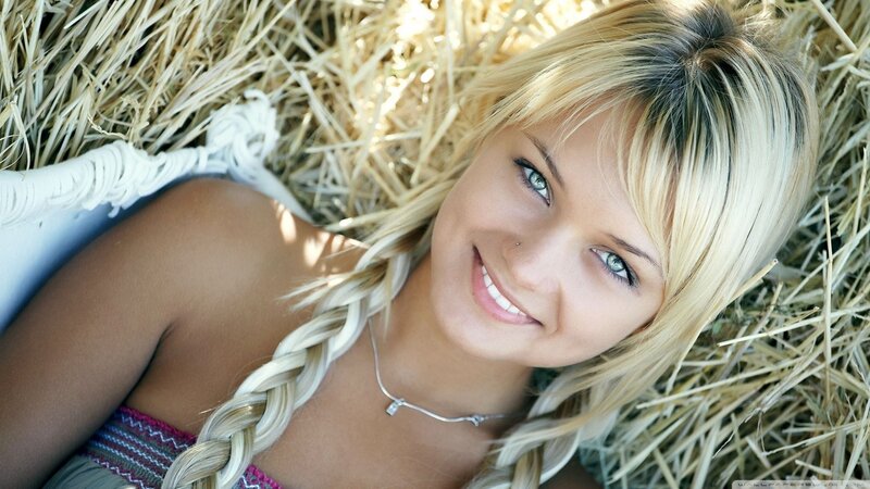 woman lying in hay smiling