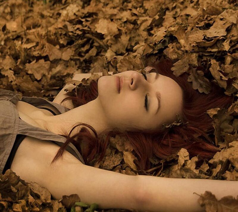 Woman Lying in Leaves — Brown, Serene