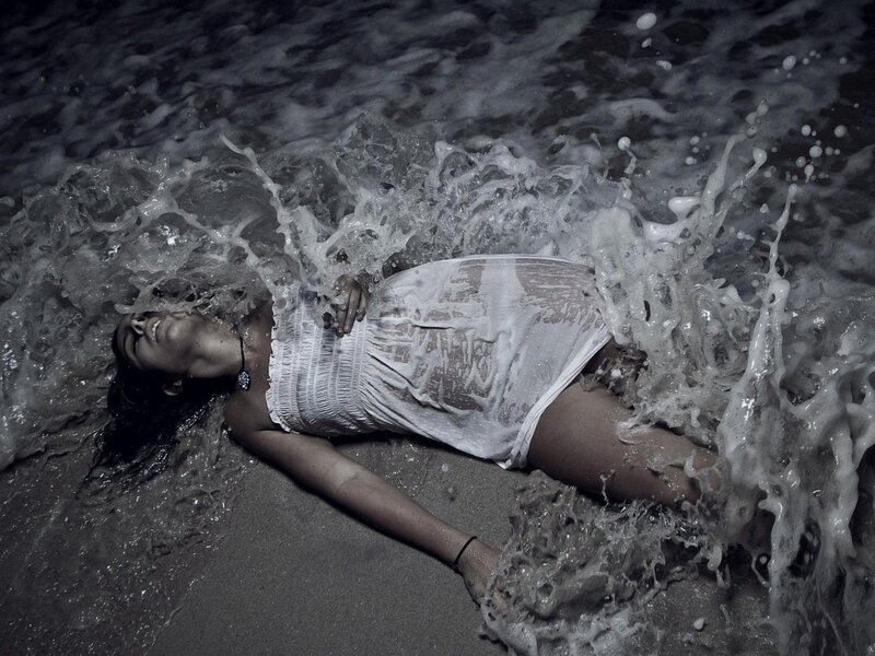 Woman lying in ocean waves
