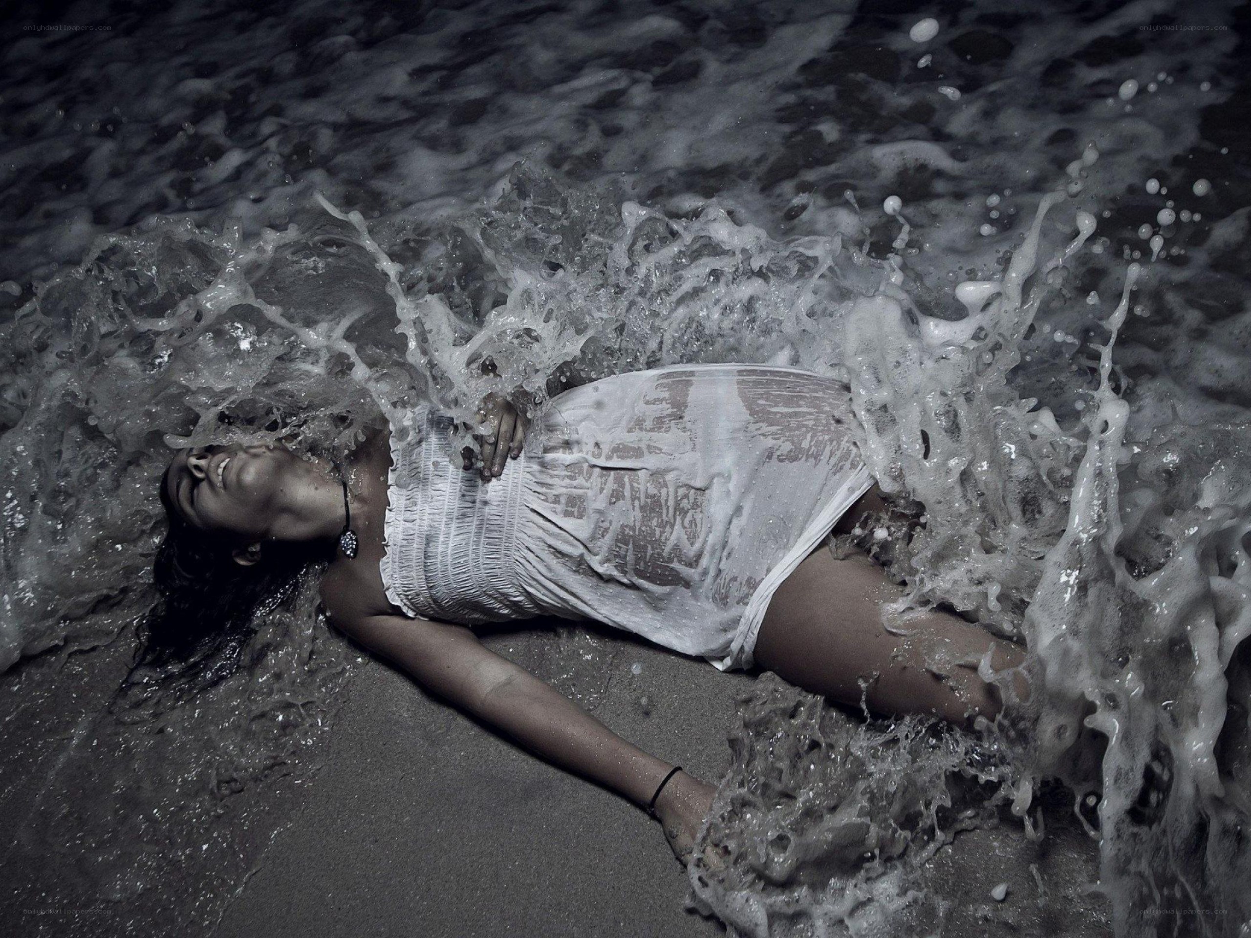 Woman lying in ocean waves