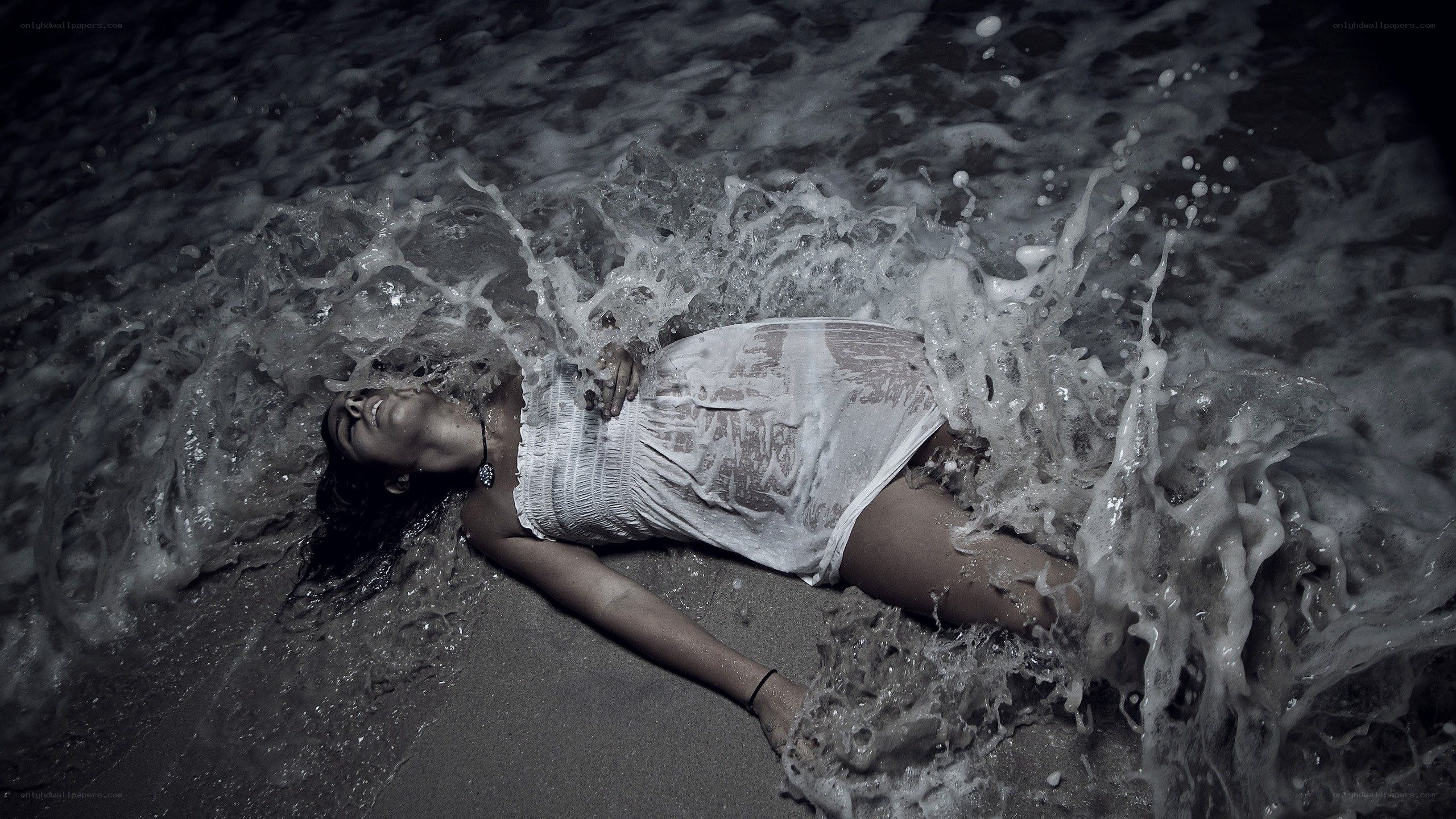 woman lying in ocean waves