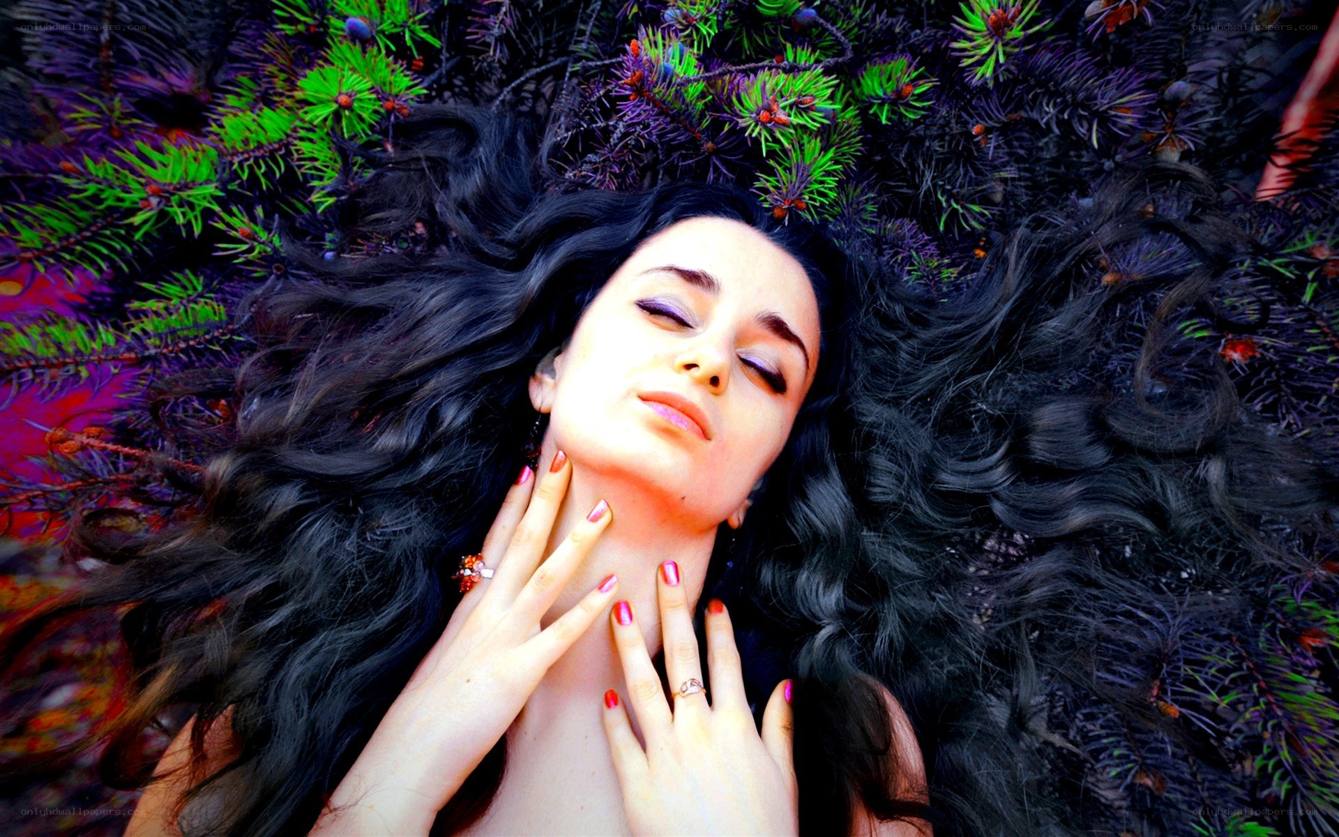 woman lying in pine branches