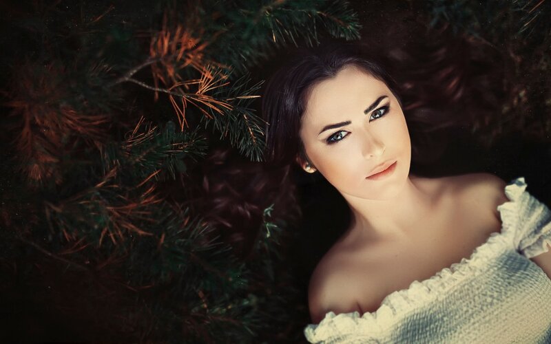 Woman Lying in Pine Needles