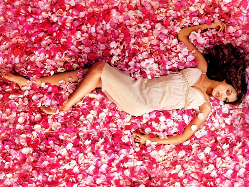 woman lying in rose petals