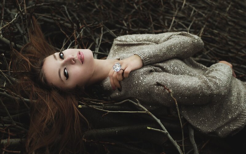 woman lying in twigs