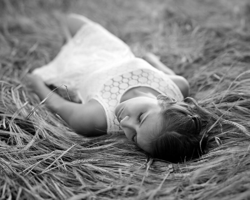 Woman Lying in Wheat Field — Black, Serene