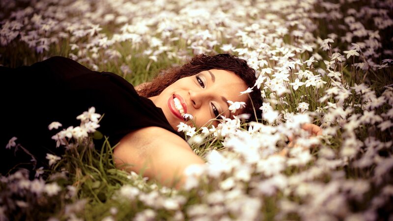 woman lying in white flowers