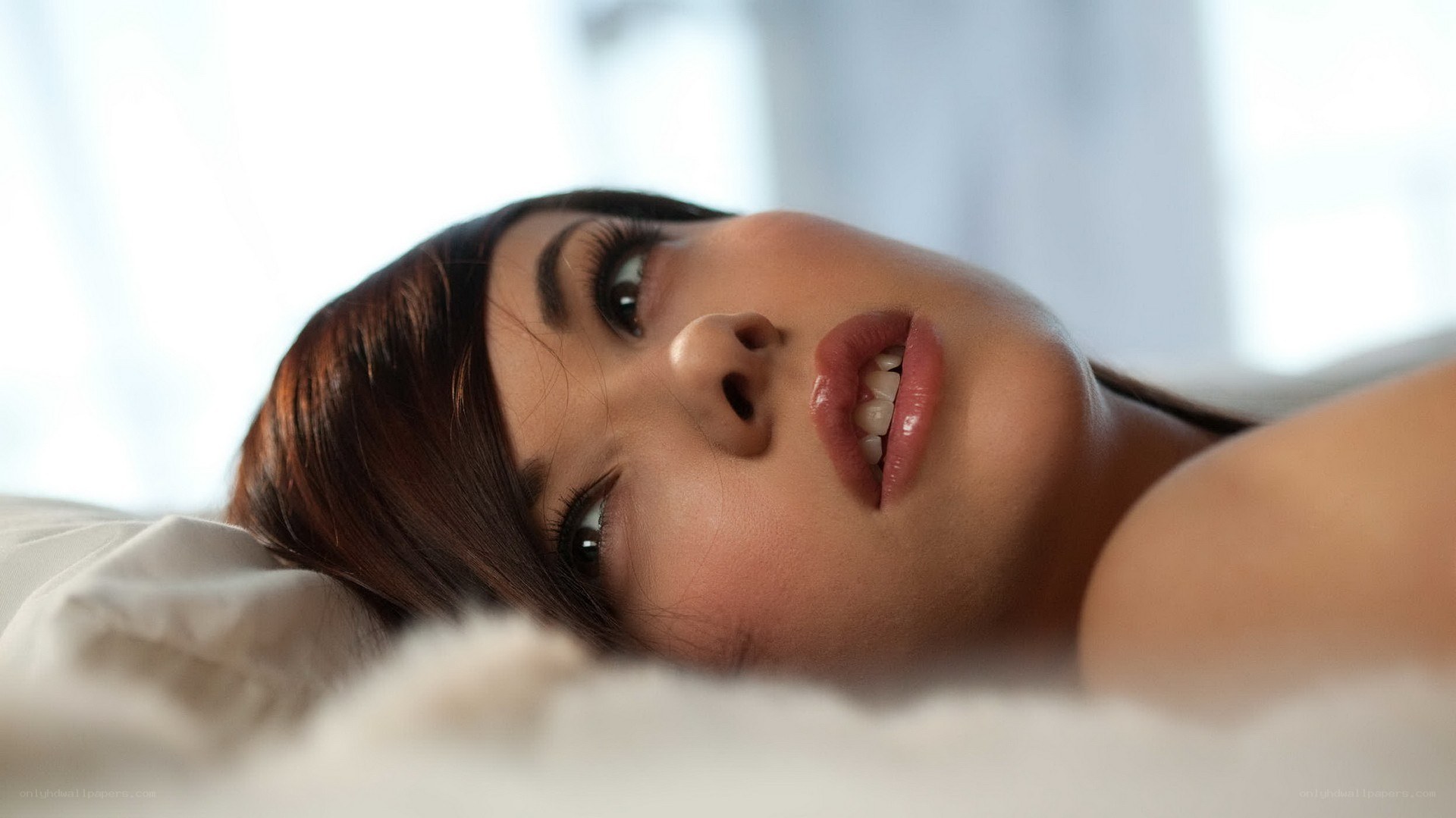 woman lying on a bed