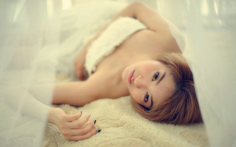 woman lying on a bed