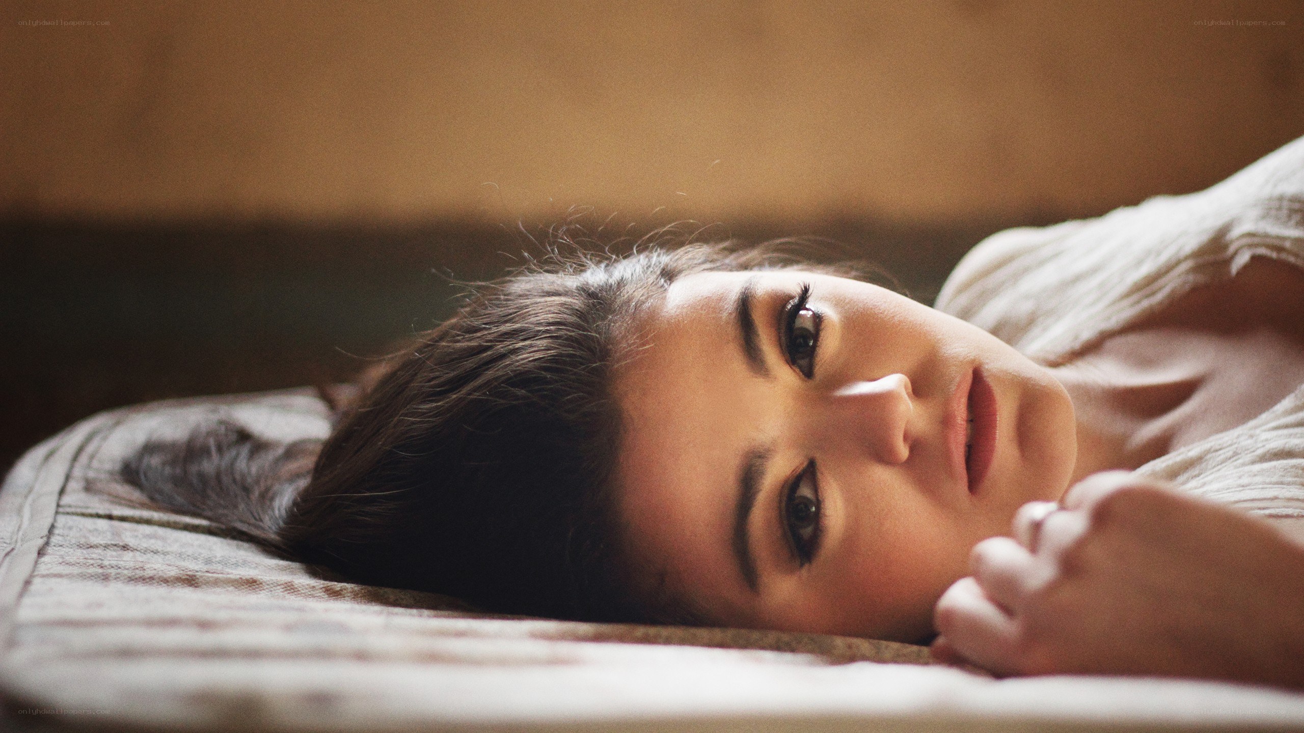 woman lying on a bed