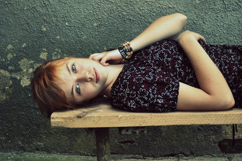 woman lying on a bench