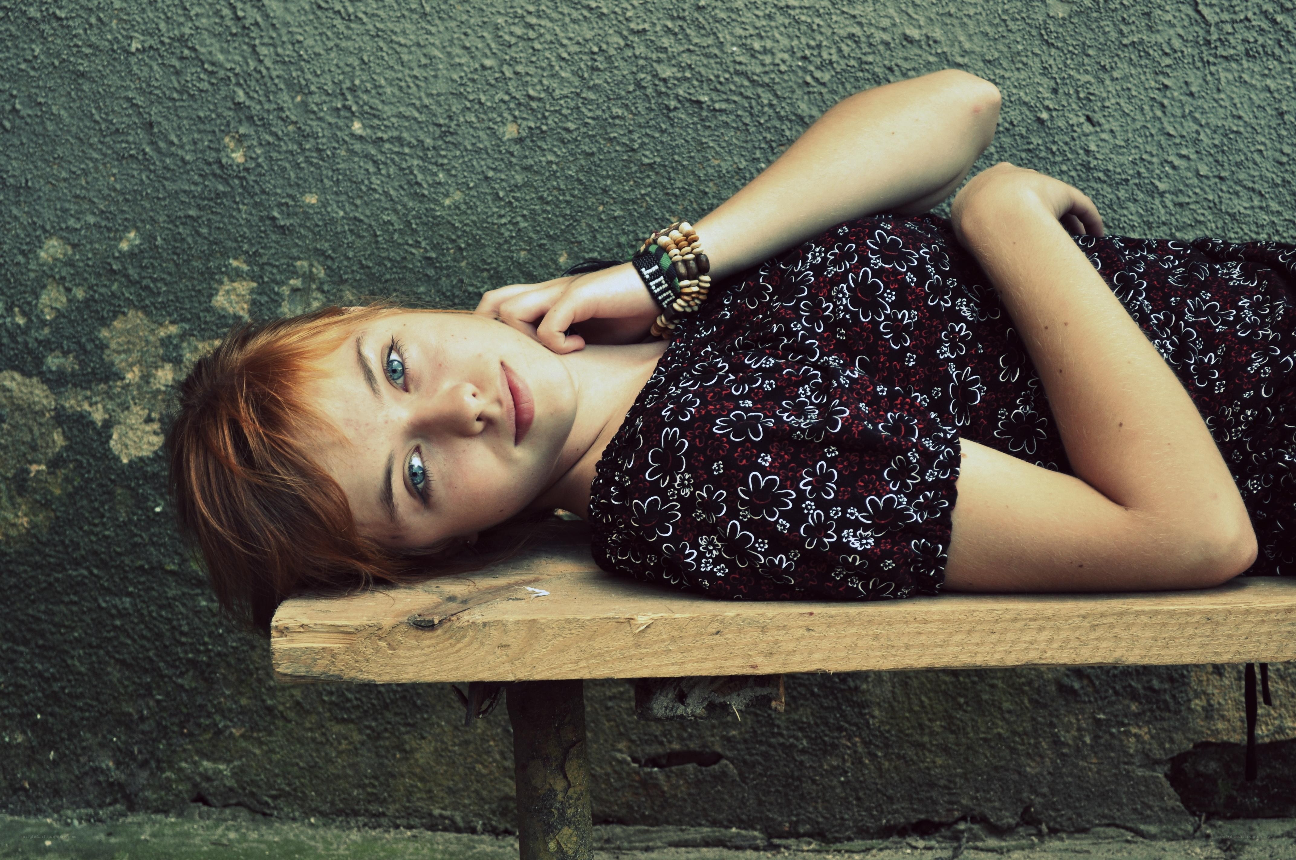 woman lying on a bench