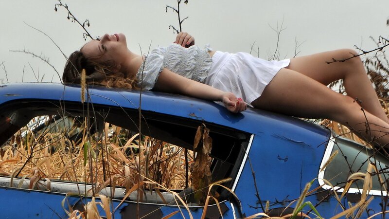 Woman lying on a car