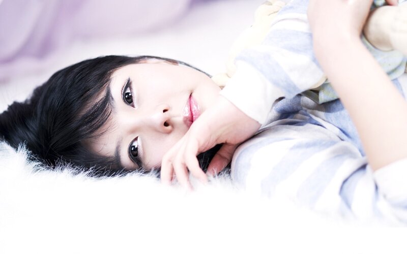 woman lying on a fluffy surface