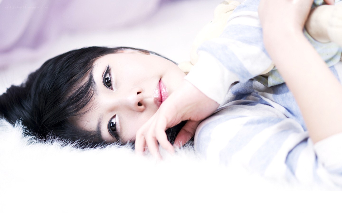 woman lying on a fluffy surface