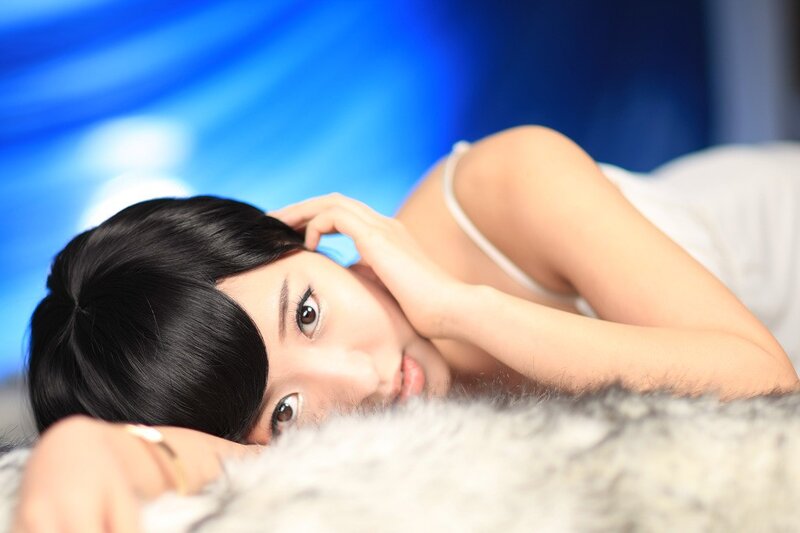 woman lying on a furry surface