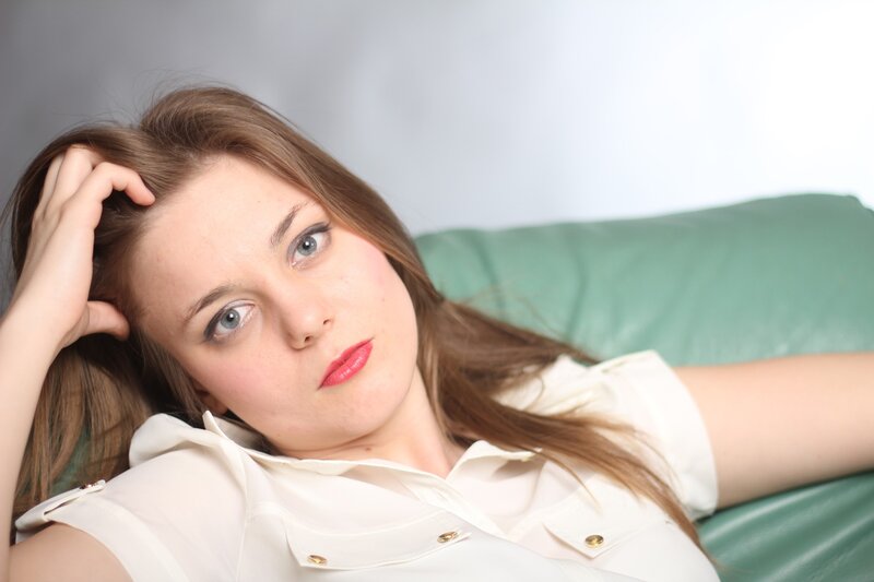 woman lying on a green couch
