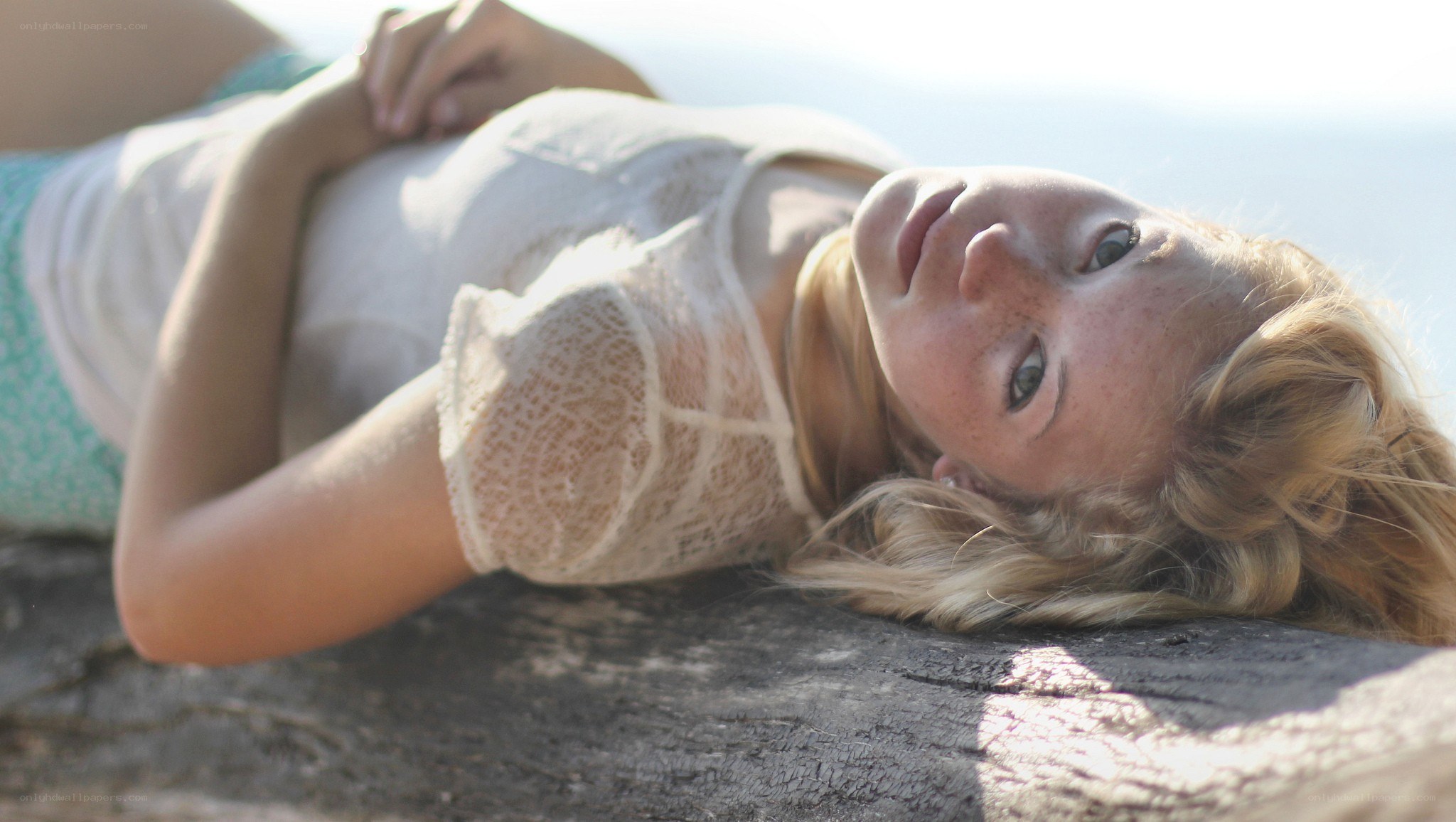 woman lying on a log