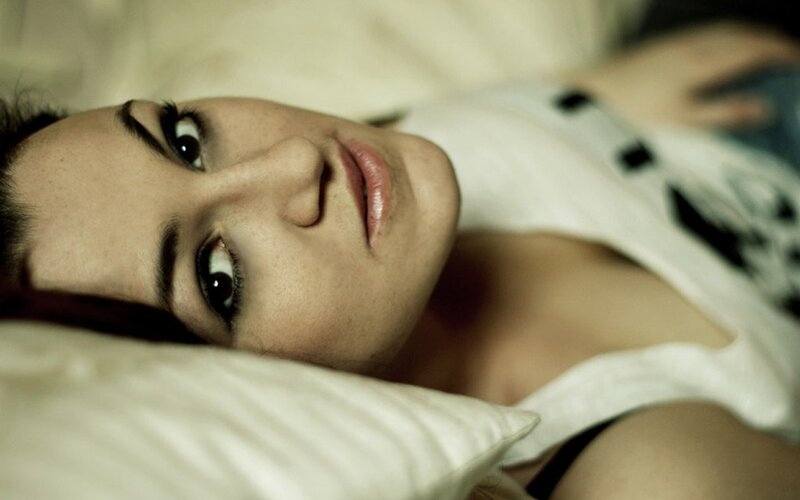 woman lying on a pillow