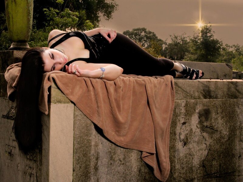 woman lying on a tombstone