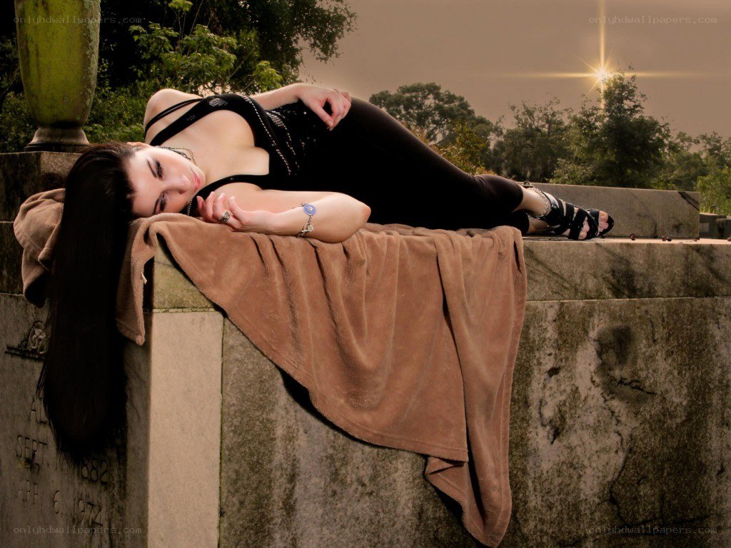 woman lying on a tombstone