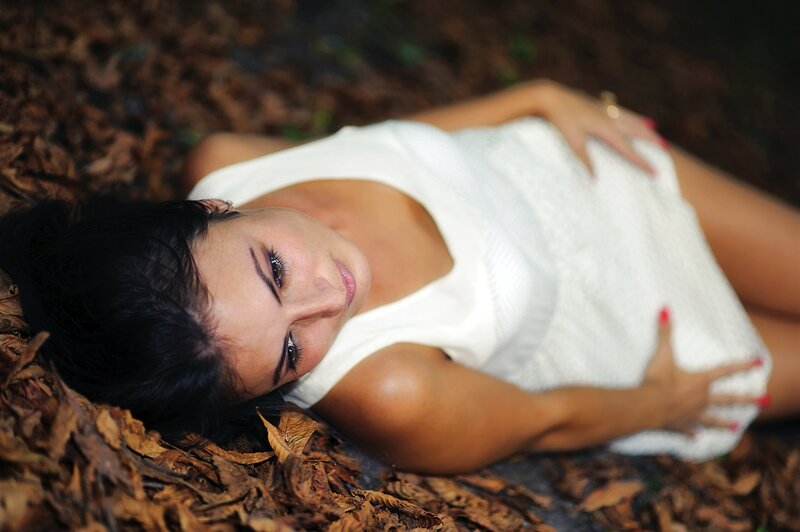 Woman lying on autumn leaves