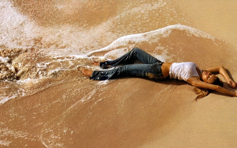Woman lying on beach