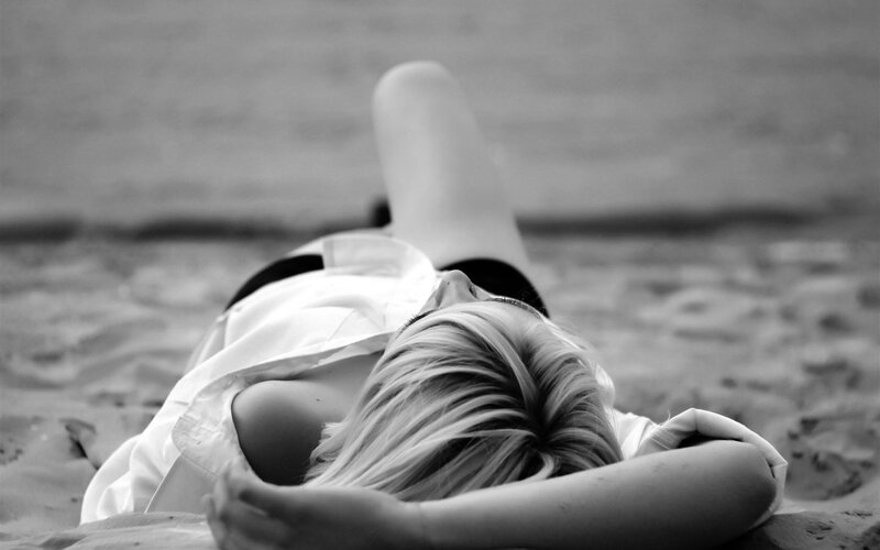 Woman Lying on Beach — Black, Calm, Afternoon