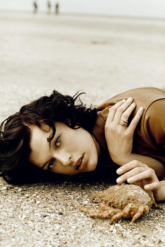 woman lying on beach with crab