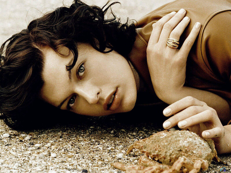 woman lying on beach with crab