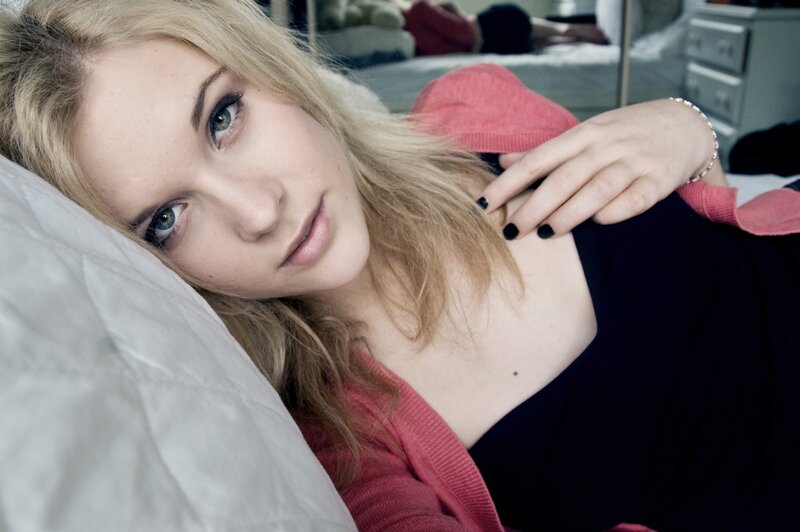 Woman Lying on Bed — Black, Calm, Photograph, Pillow, Cardigan
