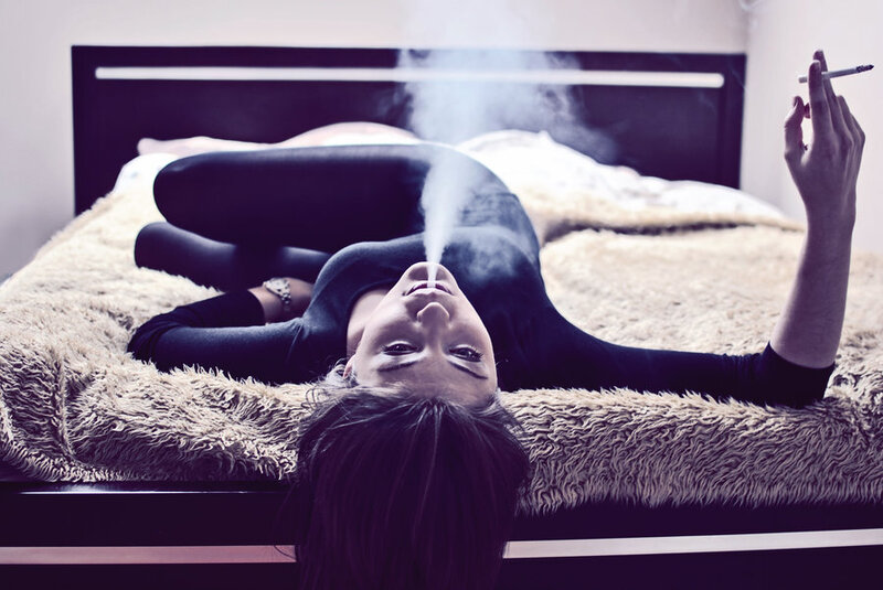 Woman Lying on Bed — Black, Dramatic, Photograph, Cigarette
