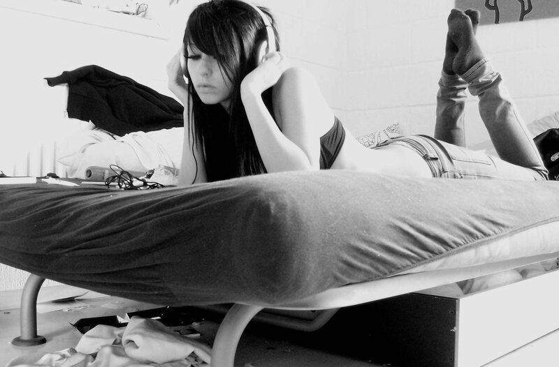Woman Lying on Bed — Black, Relaxed, Photograph, Headphones