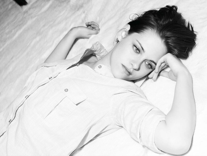 woman lying on bed in black and white