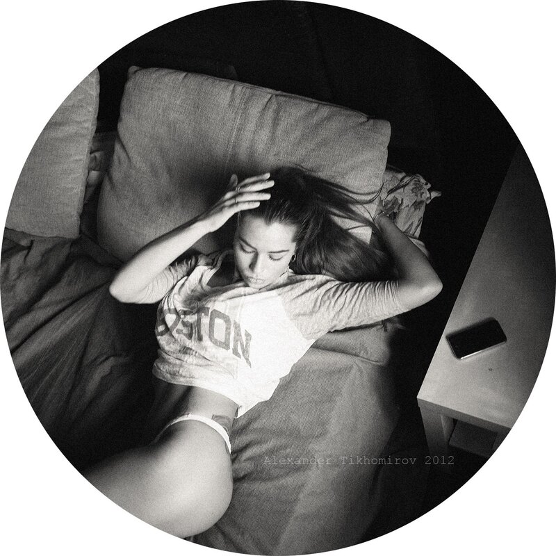 woman lying on bed in black and white