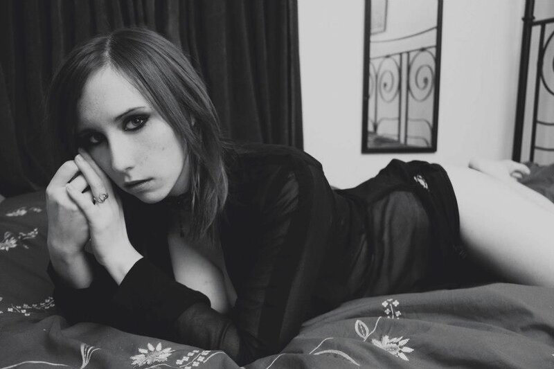 woman lying on bed in black