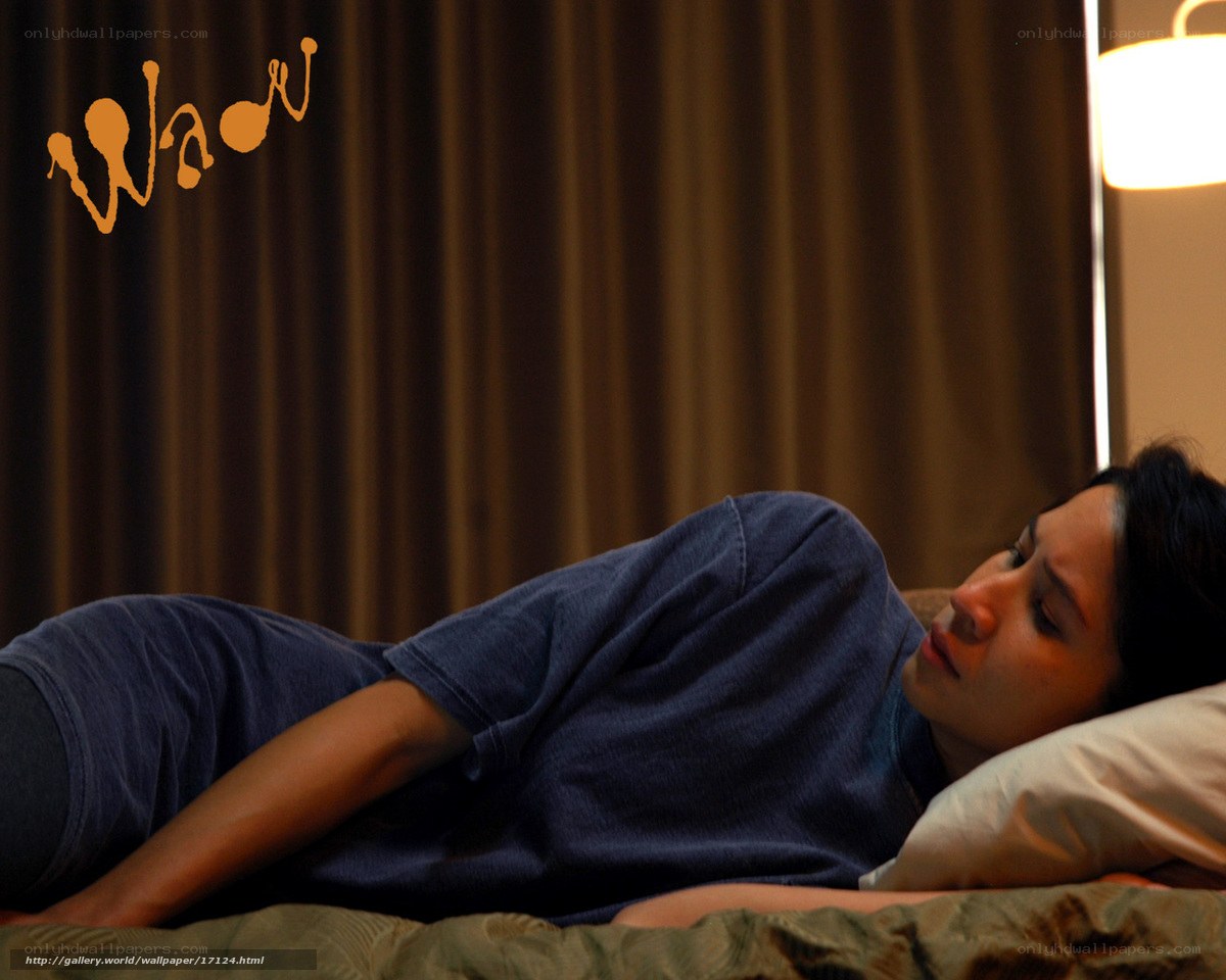 woman lying on bed in dim light