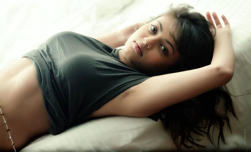 woman lying on bed in gray shirt