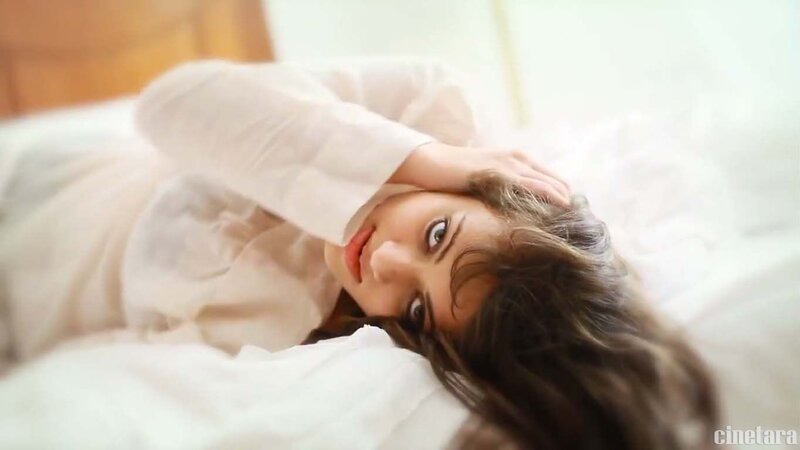 woman lying on bed in white shirt