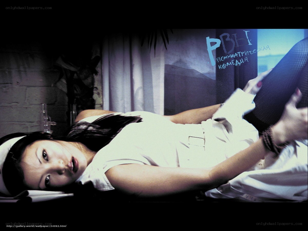 woman lying on bed in white shirt