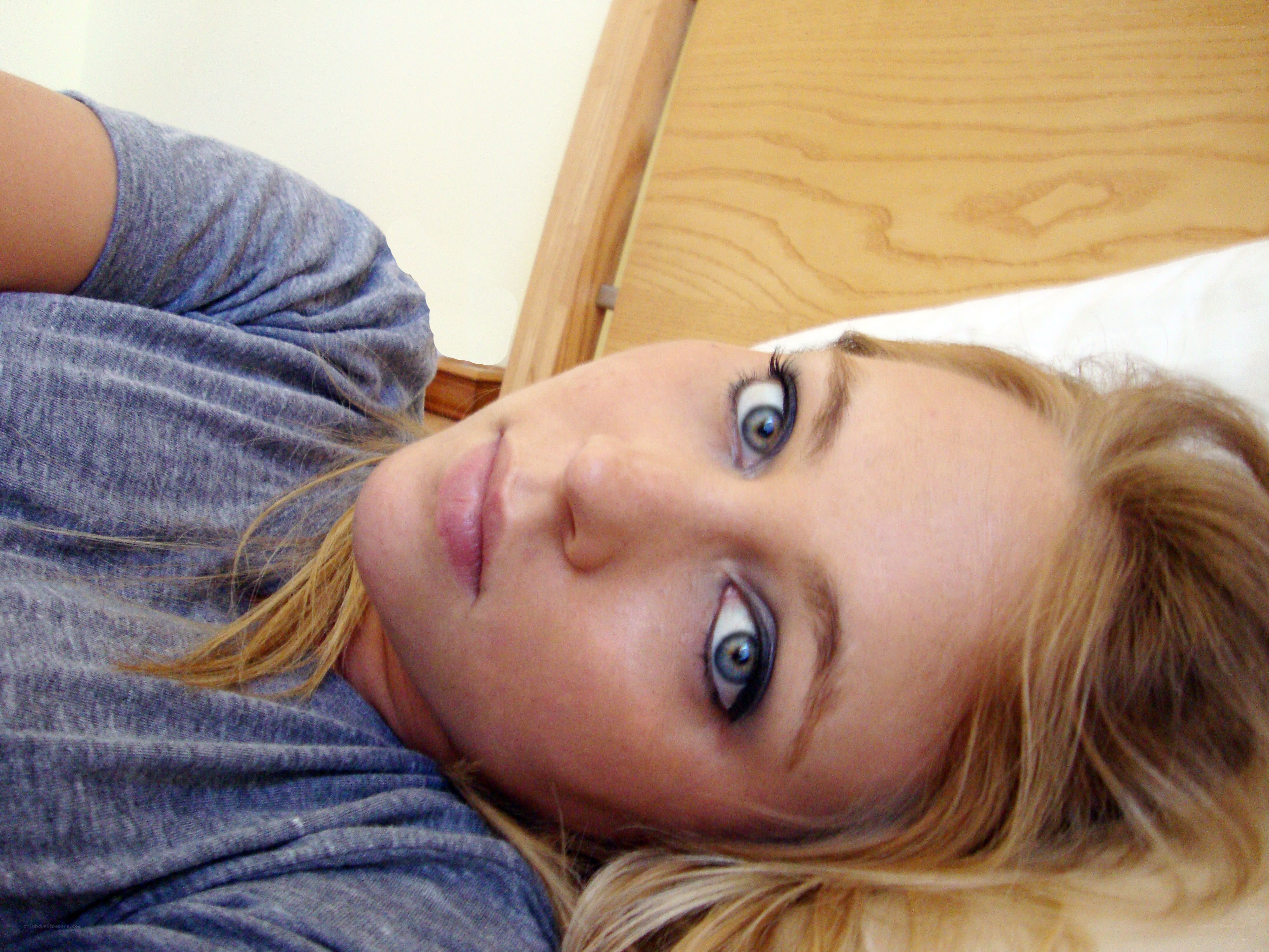 woman lying on bed looking at camera
